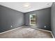 Bedroom with neutral carpet flooring, a window with a view, and neutral wall paint at 2476 Magellan Ave, Spring Hill, FL 34608