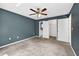 Bedroom featuring neutral carpet, ceiling fan, and an open closet with white doors at 2476 Magellan Ave, Spring Hill, FL 34608