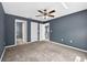 Bedroom featuring neutral carpet, ceiling fan, and doorways to other rooms at 2476 Magellan Ave, Spring Hill, FL 34608