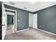 Bedroom with neutral carpet flooring, neutral wall paint, closet and a view to the home's hallway at 2476 Magellan Ave, Spring Hill, FL 34608
