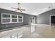 Open-concept living space featuring tile floors, gray paint, and access to outdoor area at 2476 Magellan Ave, Spring Hill, FL 34608