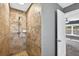 Tiled shower with mosaic accents and a view into the bathroom at 2476 Magellan Ave, Spring Hill, FL 34608
