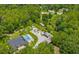 Wide aerial shot shows estate with swimming pool, boat storage, extensive landscaping, and mature trees at 26221 Pheasant Run, Wesley Chapel, FL 33544