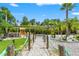 Backyard area featuring a charming pergola, outdoor seating, lush landscaping, and a tranquil ambiance at 26221 Pheasant Run, Wesley Chapel, FL 33544