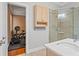 Bathroom showcasing vanity and glass-enclosed shower, adjacent to a workout space at 26221 Pheasant Run, Wesley Chapel, FL 33544