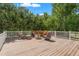 Spacious wooden deck with cozy seating, fire pit, and serene wooded views at 26221 Pheasant Run, Wesley Chapel, FL 33544