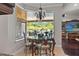 Cozy dining area offering natural light and views of outdoor living spaces at 26221 Pheasant Run, Wesley Chapel, FL 33544