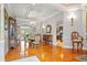 Spacious dining area with elegant wood floors and classic décor, perfect for entertaining guests at 26221 Pheasant Run, Wesley Chapel, FL 33544