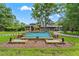 Beautiful home with lush landscaping, a tiered pool, and a spacious front yard at 26221 Pheasant Run, Wesley Chapel, FL 33544