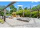 Outdoor fire pit area with tiki bar, seating, and stone accents perfect for entertaining at 26221 Pheasant Run, Wesley Chapel, FL 33544