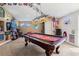 Spacious game room featuring a pool table, dart machine, and sports decorations at 26221 Pheasant Run, Wesley Chapel, FL 33544