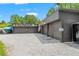 Exterior of a large garage with multiple bays, ample parking, and unique signage at 26221 Pheasant Run, Wesley Chapel, FL 33544