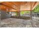 Spacious garage featuring stone accents, wood ceilings and brick paver flooring at 26221 Pheasant Run, Wesley Chapel, FL 33544