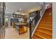 Gourmet kitchen with island, custom cabinets, and stainless steel appliances, adjacent to stairs at 26221 Pheasant Run, Wesley Chapel, FL 33544