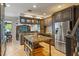 Well-appointed kitchen with granite counters, island, stainless appliances, and seamless living area at 26221 Pheasant Run, Wesley Chapel, FL 33544