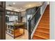 Well-equipped kitchen with island, custom cabinetry, and stainless steel refrigerator, with stairs nearby at 26221 Pheasant Run, Wesley Chapel, FL 33544