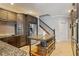 Spacious kitchen boasts granite countertops, stainless steel appliances, and adjacent staircase at 26221 Pheasant Run, Wesley Chapel, FL 33544
