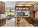 Open kitchen features granite countertops, island, and views to the outside dining area at 26221 Pheasant Run, Wesley Chapel, FL 33544