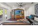 Spacious living room with elegant wood floors, entertainment center, and comfortable leather seating at 26221 Pheasant Run, Wesley Chapel, FL 33544