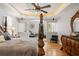 Well-appointed main bedroom featuring hardwood floors, detailed trim, and comfortable sitting area at 26221 Pheasant Run, Wesley Chapel, FL 33544