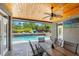 Relaxing covered patio with dining table and pool view, ideal for outdoor entertaining at 26221 Pheasant Run, Wesley Chapel, FL 33544
