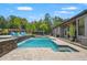Beautiful pool with waterfall feature and spa, surrounded by manicured landscaping at 26221 Pheasant Run, Wesley Chapel, FL 33544