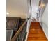 Wooden staircase with decorative rail leading to upper level, adjacent to kitchen at 26221 Pheasant Run, Wesley Chapel, FL 33544