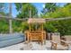 Outdoor tiki bar area with seating, perfect for entertaining at 26221 Pheasant Run, Wesley Chapel, FL 33544