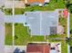 An aerial view of a single-Gathering home with a gray roof, green grass, and patio area at 3204 Payne St, New Port Richey, FL 34655