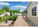 Landscaped backyard with a brick paver walkway and lush greenery for added privacy at 3204 Payne St, New Port Richey, FL 34655