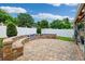 Spacious backyard boasts brick pavers, ample seating, and lush landscaping for outdoor enjoyment at 3204 Payne St, New Port Richey, FL 34655