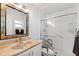 Clean bathroom with updated shower with glass door, elegant vanity, and a neutral color scheme at 3204 Payne St, New Port Richey, FL 34655