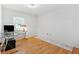 Bright bedroom features hardwood floors, natural light, and a neutral color palette at 3204 Payne St, New Port Richey, FL 34655