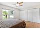 Comfortable bedroom with bright natural light and ample closet space, finished with warm wood flooring at 3204 Payne St, New Port Richey, FL 34655