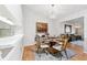 Elegant dining room with hardwood floors and a stylish chandelier, adjacent to the kitchen and living area at 3204 Payne St, New Port Richey, FL 34655