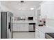 Modern kitchen featuring white cabinets, stainless steel appliances, and a bright, open layout at 3204 Payne St, New Port Richey, FL 34655