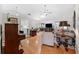 Open-concept living area with hardwood floors seamlessly connecting the living room, dining area, and kitchen at 3204 Payne St, New Port Richey, FL 34655
