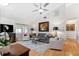 Bright living room featuring a vaulted ceiling, hardwood floors, and tastefully appointed furnishings at 3204 Payne St, New Port Richey, FL 34655