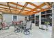 Relaxing covered patio includes a dining table for outdoor entertaining with lush scenery at 3204 Payne St, New Port Richey, FL 34655