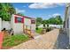 Backyard shed with access ramp situated amongst lush landscaping and brick pavers at 3204 Payne St, New Port Richey, FL 34655