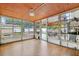 Enclosed sunroom with tile flooring, ceiling fan, and multiple windows with backyard views at 3204 Payne St, New Port Richey, FL 34655