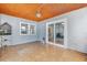 Light-filled sunroom boasts tile flooring, unique bamboo ceiling, and sliding glass doors at 3204 Payne St, New Port Richey, FL 34655