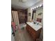 Updated bathroom with a tiled shower, modern vanity, and decorative lighting at 3252 Columbus Dr, Holiday, FL 34691