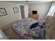 Cozy bedroom with patterned bedding, dresser, and artwork at 3252 Columbus Dr, Holiday, FL 34691