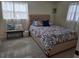 Relaxing bedroom featuring patterned bedding, natural light, and a comfortable bench at 3252 Columbus Dr, Holiday, FL 34691