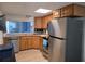 Well-equipped kitchen with stainless steel appliances, wooden cabinetry, and a bright window at 3252 Columbus Dr, Holiday, FL 34691