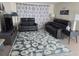 Comfortable living room featuring reclining sofa and loveseat, complemented by a decorative area rug at 3252 Columbus Dr, Holiday, FL 34691