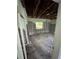 The bedroom is showing exposed walls, flooring, and ceiling; the space is in need of renovations to be habitable at 34767 Evergreen Way, Ridge Manor, FL 33523