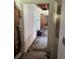 Hallway view with exposed studs and wall damage indicating renovation work at 34767 Evergreen Way, Ridge Manor, FL 33523
