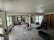 Renovation view of the living room with exposed studs and debris at 34767 Evergreen Way, Ridge Manor, FL 33523
